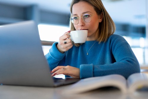 Jonge vrouw koffie laptop